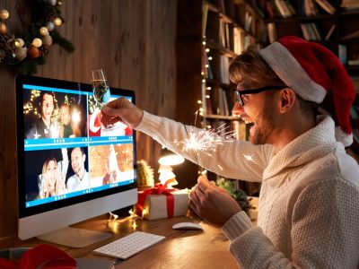 Young,Man,Wearing,Christmas,Hat,Drinking,Champagne,Holding,Sparkler,Talking