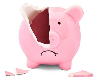 Close,Up,Of,A,Broken,Pink,Piggy,Bank,On,White