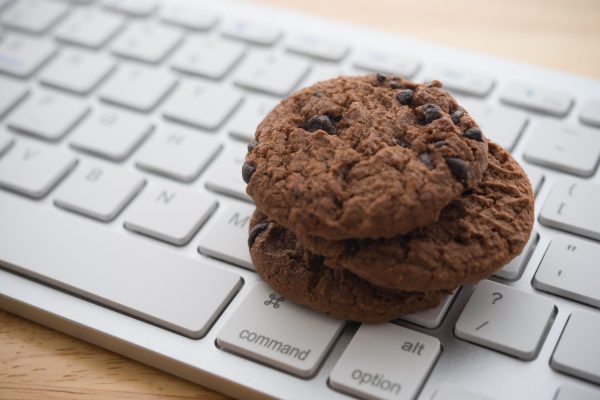 Chocolate,Chip,Cookies,On,Keyboard,Computer,Background,Copy,Space.,Cookies